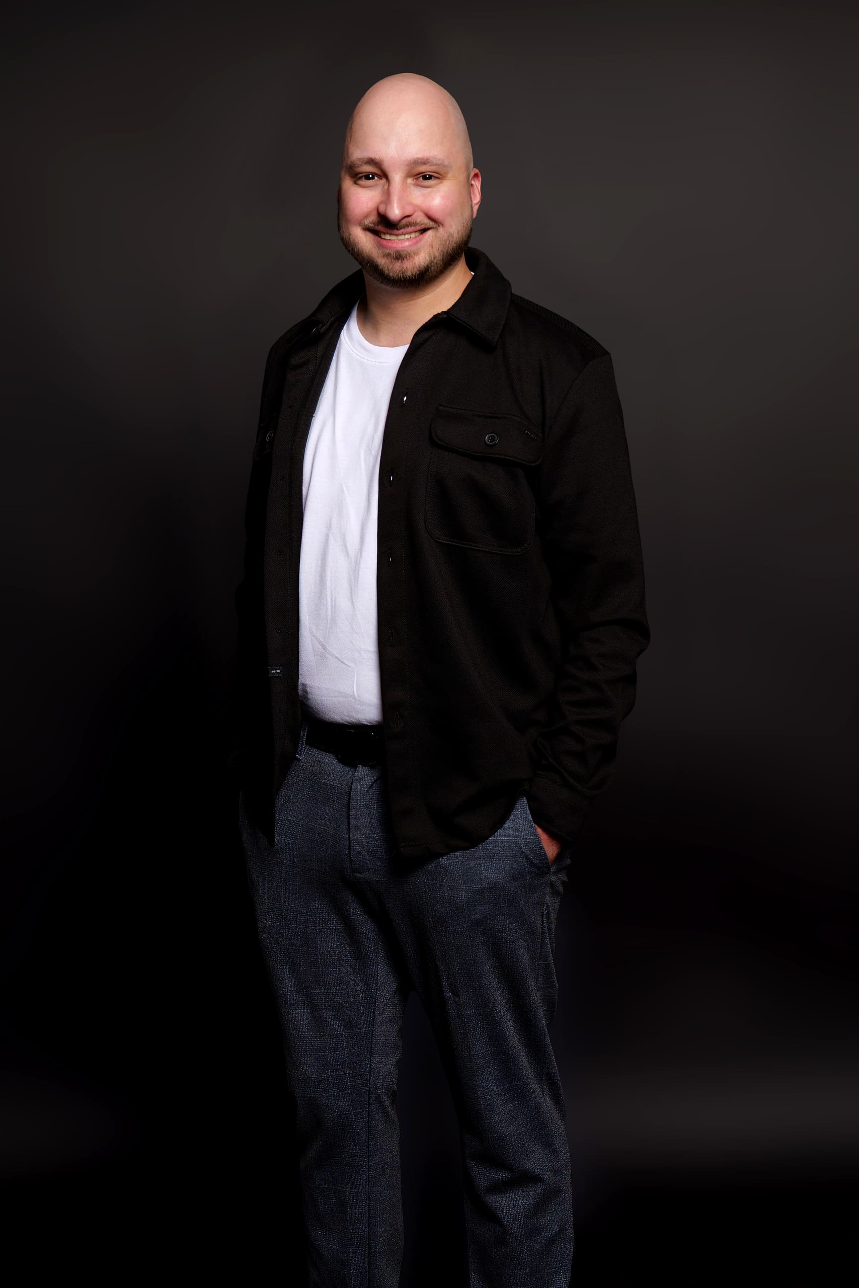 Frank Schlattmann, co-founder of Everstern, stands in front of a dark studio backdrop with one hand in his pocket, smiling at the camera.